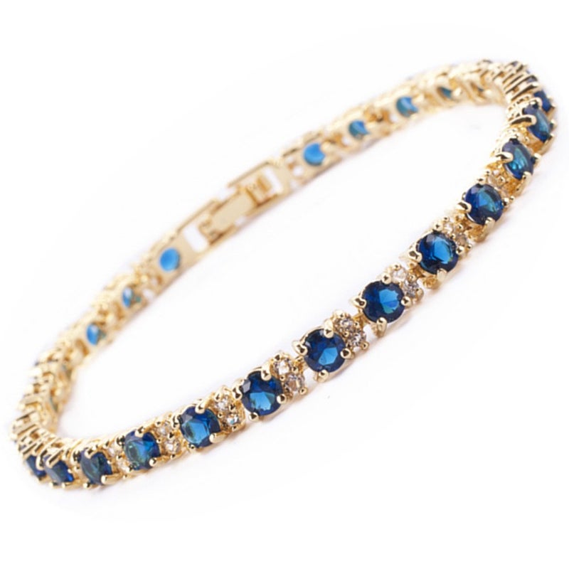 RIZILIA Eternity Tennis Bracelet & Round Cut CZ Simulated Blue Sapphire in Yellow Gold Plated, 7" - Image 1
